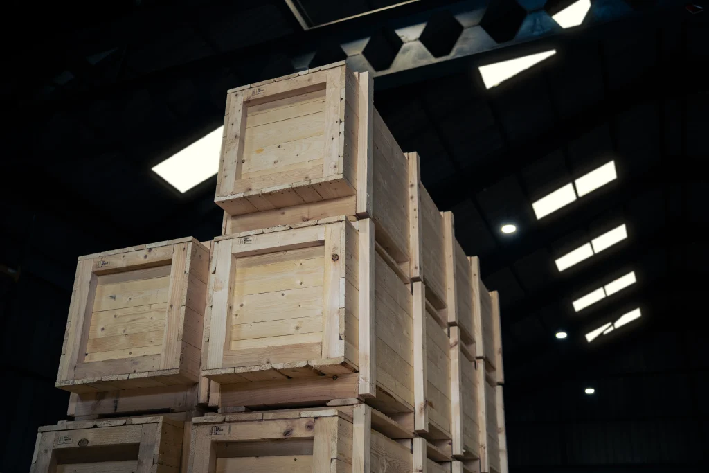 Stacked ISPM 15 timber export crates inside IM Export Services warehouse