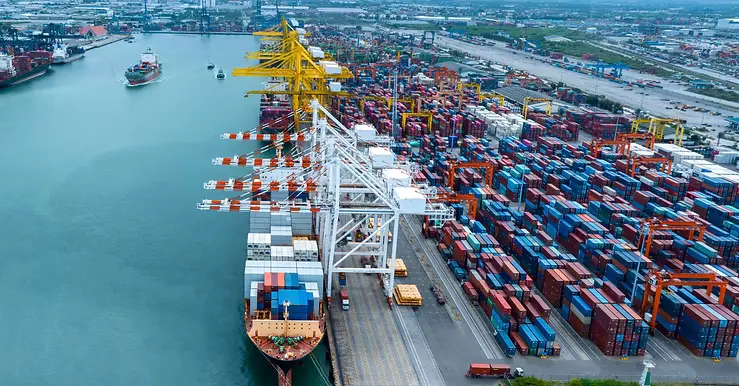 Shipping containers being loaded onto a cargo ship.